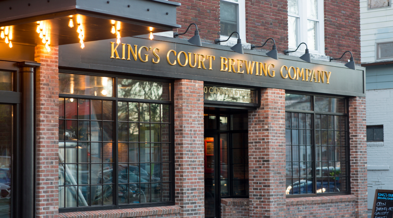 brick exterior of Kings court brewing company in poughkeepsie with gold colored signage